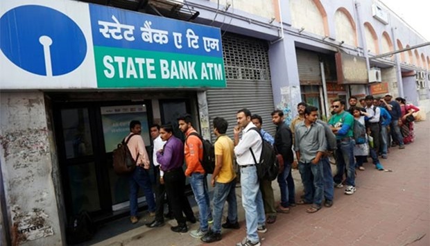 People queue outside a State Bank of India ATM in Kolkata.