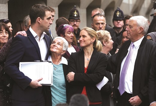 Brendan Cox, husband of MP Jo Cox, is embraced by his mother-in-law Jean Leadbeater, as his sister-in-law Kim Leadbeater and father-in-law Gordon Leadbeater look on outside the Old Bailey courthouse after the conviction and sentencing of Thomas Mair for his wifeu2019s murder, in London.