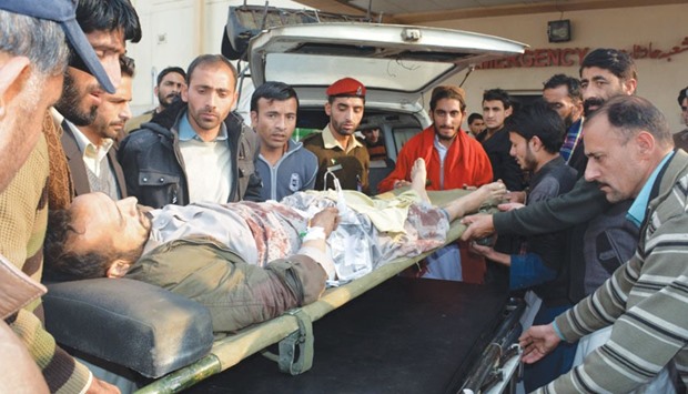 Pakistani Kashmiris shift an injured victim from the passenger bus hit in cross-border shelling, at a military hospital in Muzaffarabad, the capital of Pakistan-administered Kashmir yesterday.