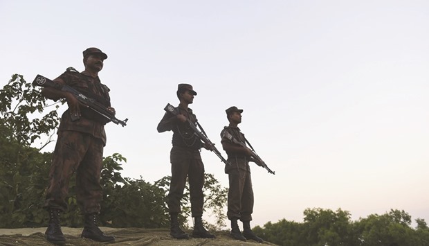 Border Guard Bangladesh (BGB) personnel watch for the illegal entry of Myanmar Rohingya refugees on the banks of the Naf River, near Teknaf in southern Coxu2019s Bazaar district, yesterday.