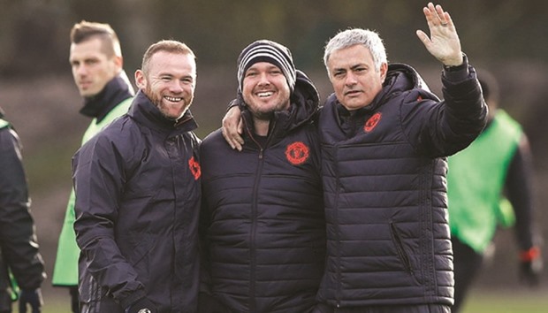 Manchester United manager Jose Mourinho with Wayne Rooney (left) and team's sports therapist Rod Thornley during a training session. (Reuters)