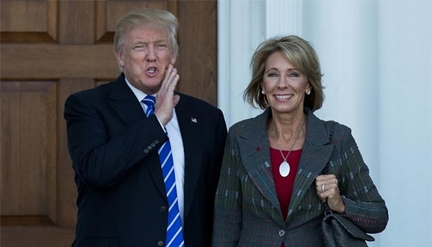 Donald Trump is seen with Betsy DeVos after their meeting at Trump International Golf Club, in Bedminster Township, New Jersey, last week.