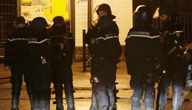 French police stand on a street