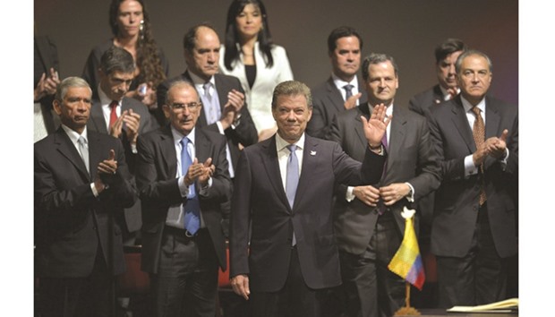Colombian President Juan Manuel Santos (centre) waves during the second signing of the historic peace agreement between the Colombian government and the Farc at the Colon Theatre in Bogota, Colombia, yesterday.