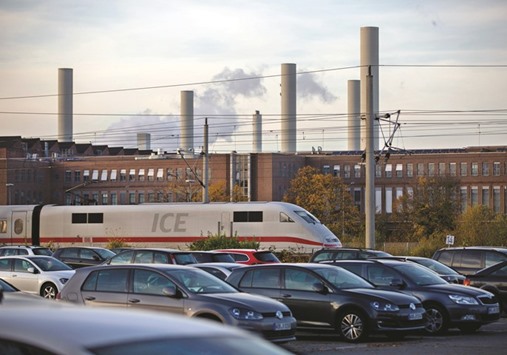 A Deutsche Bahn InterCity Express (ICE) train travels past the Volkswagen factory in Wolfsburg, Germany. The countryu2019s quarterly growth rate halved to 0.2% in the three months to September even though private consumption and state spending rose, as weak foreign trade slowed overall activity in Europeu2019s biggest economy.
