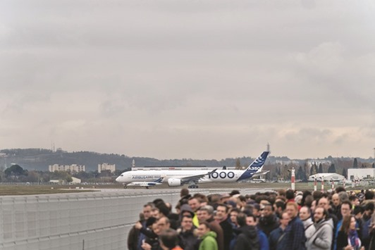 An A350-1000 twinjet passenger plane is on the runway ahead of take off from the Airbus factory in Toulouse. The lightweight carbon-fibre plane, 7 metres longer and able to carry 40 more people than A350s already in service, began a three-hour debut flight at 0942 GMT yesterday.