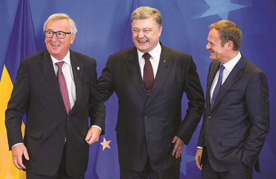 Poroshenko with European Commission President Jean-Claude Juncker (left) and European Council President Donald Tusk (right) during the EU-Ukraine summit in Brussels.