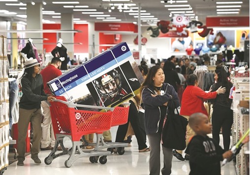 Thanksgiving Day shoppers push loaded up carts during the u201cBlack Fridayu201d sales at a Target store in Culver City, California on November 24, 2016.  US retailers kicked off the unofficial start of the holiday retail season with sales that begin on the Thanksgiving holiday.