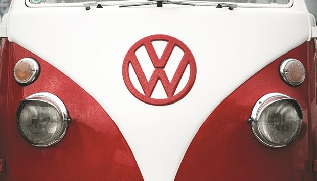 A Volkswagen badge is seen on a VW Split Screen Camper van automobile displayed on the forecourt of a dealership in Vienna. In Florence, two VW fans have dedicated their lives to restoring these iconic vans from the Swinging Sixties, importing them from South America before fixing them up and selling them on.