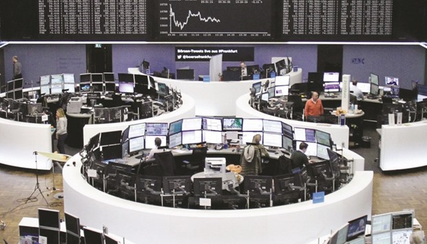Traders work inside the stock exchange in Frankfurt. The DAX 30 edged up 0.09% at 10,699.27 points yesterday.