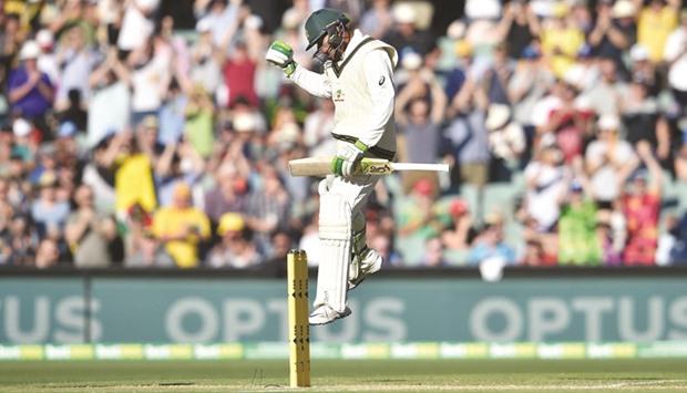 Australian batsman Usman Khawaja celebrates after making a 100 during the second day of the third Test against South Africa.