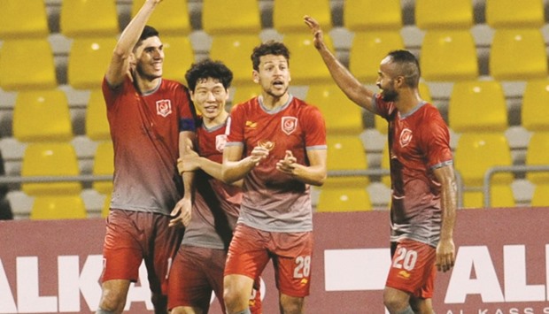 Captain Karim Boudaif is congratulated by his Lekhwiya teammates after scoring the winning goal for his side.
