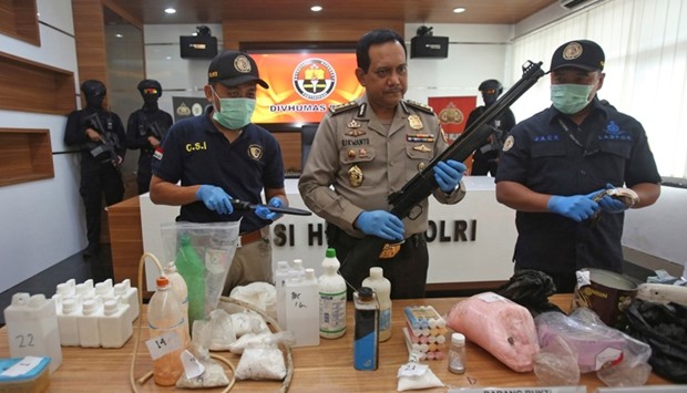 Indonesian police show items recently seized, including weapons and bomb-making materials, that they say were intended for use to attack government buildings and the Myanmar embassy, at police headquarters in Jakarta.