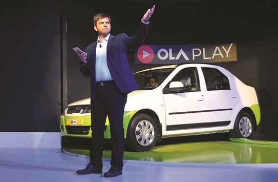 Bhavish Aggarwal, CEO and co-founder of Ola, gestures as he addresses the  media during a news conference in Bengaluru, India. The company is raising funds that value it at $3bn, a sharp reduction from the $5bn figure during a  previous financing round in November 2015.