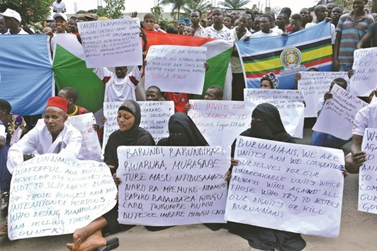 Burundians hold placards during a rally in Bujumbura yesterday to show solidarity with the governmentu2019s opposition to the appointment last week by the UN Human Rights Council of three investigators to look into human rights violations in the east African nation.