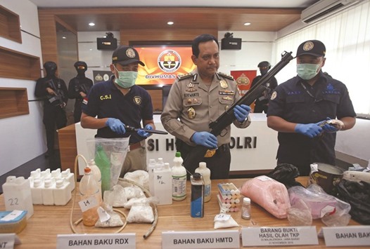 Indonesian police show items recently seized, including weapons and bomb-making materials, that they say were intended for use to attack government buildings and the Myanmar embassy, at the police headquarters in Jakarta.