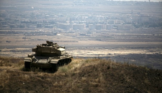 The Syrian area of Quneitra is seen in the background as an out-of-commission Israeli tank parks on a hill, near the ceasefire line between Israel and Syria, in the Israeli-occupied Golan Heights. August 21, 2015 file picture.