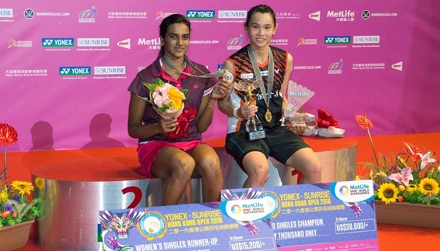 Winner Tai Tzu-ying of Taiwan (R) poses with second-placed P.V. Sindhu of India after the women's singles final at the Hong Kong Open badminton tournament in Hong Kong