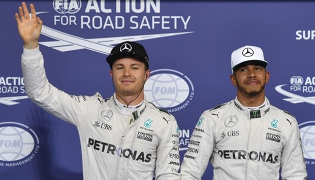 Mercedes AMG Petronas F1 Team's British driver Lewis Hamilton (R), flanked by his German teammate Ni