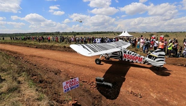 A plane prepares to take off from a dirt road used as a makeshift runway during the Vintage Air Rally at the Nairobi national park on Sunday.