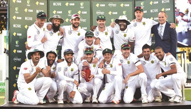 South Africa players pose for a group photo with the trophy after winning the three-Test series against Australia 2-1. The visitors lost the third and final Test by seven wickets in Adelaide yesterday but they had already clinched the series after crushing wins in the first two Tests in Perth and Hobart for their third straight series triumph Down Under. (AFP)