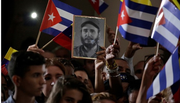 A portrait of the late former Cuban leader Fidel Castro is seen among Cuban and Venezuelan flags during his homage ceremony at the 4F military fort in Caracas, Venezuela.