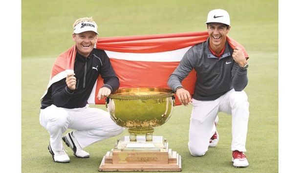 Soren Kjeldsen (L) and Thorbjorn Olesen (R) of Denmark pose with the trophy after winning the World Cup of Golf on the Kingston Heath course in Melbourne yesterday.