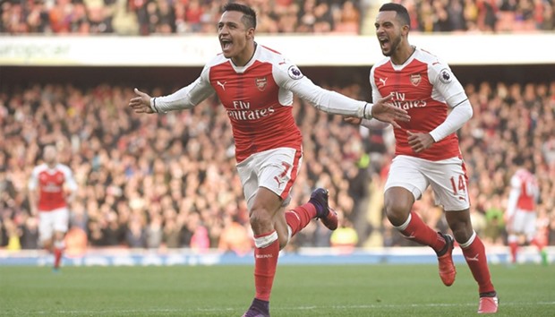 Arsenalu2019s Alexis Sanchez (left) celebrates his goal against Bournemouth during their Premier League match at the Emirates Stadium in London yesterday. (Reuters)