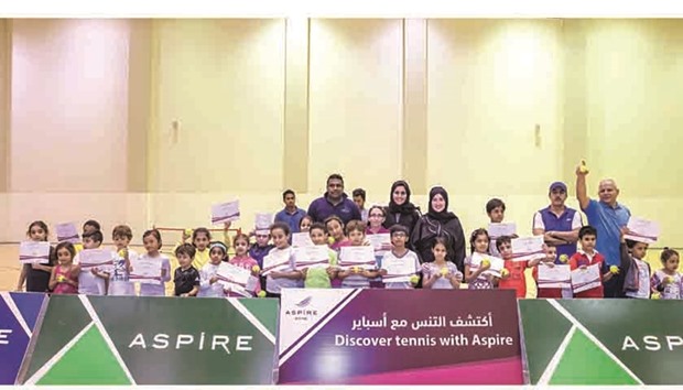 Participants pose with certificates after the u2018Discover Tennis with Aspireu2019 training camp.