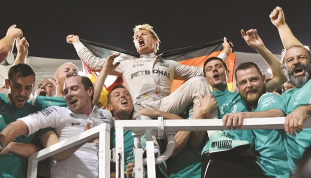 Mercedes AMG Petronas F1 Teamu2019s German driver Nico Rosberg celebrates with teammates at the end of the Abu Dhabi Formula One Grand Prix at the Yas Marina circuit yesterday. Rosberg won his maiden F1 title by securing second place yesterday.
