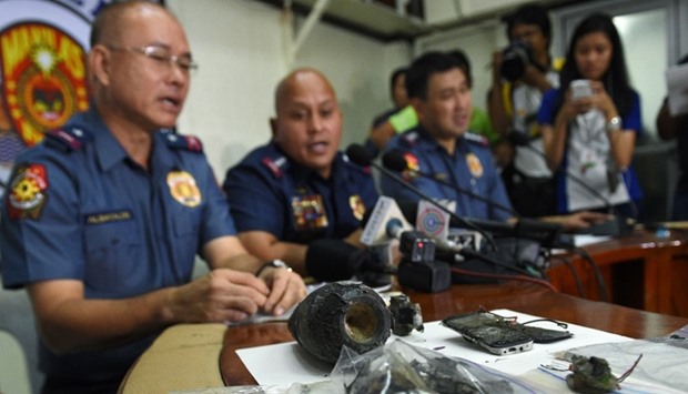 Philippine police chief Director-General Ronald Dela Rosa talks about the improvised explosive device found by a street sweeper near the US embassy during a press conference at the police headquarters in Manila on November 28, 2016, as police metro chief Chief Philippine police Oscar Albayalde (L) and Manila district police chief Senior Superintendent Joel Coronel (R) look on.