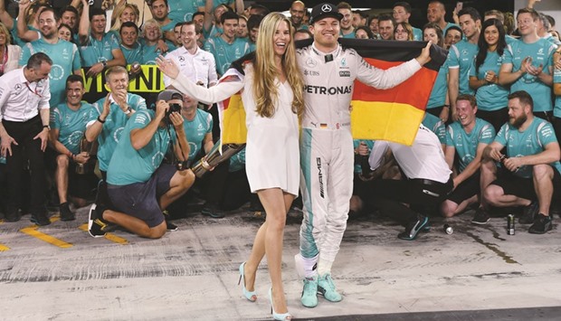 Mercedes AMG Petronas F1 Teamu2019s German driver Nico Rosberg (C-R) celebrates with his wife Vivian Sibold and members of his team at the end of the Abu Dhabi Formula One Grand Prix  on Sunday.