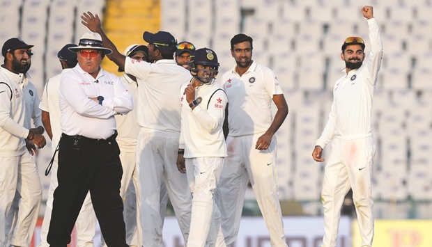 Indian captain Virat Kohli (R) celebrates after R Ashwin (C) dismissed England batsman Ben Stocks yesterday.