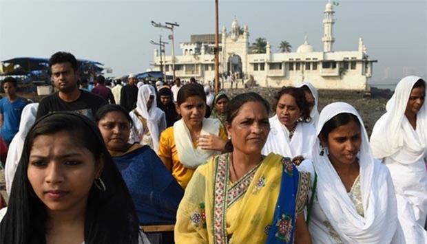Indian women leave after visiting the inner sanctum of the Haji Ali Dargah in Mumbai on Tuesday.