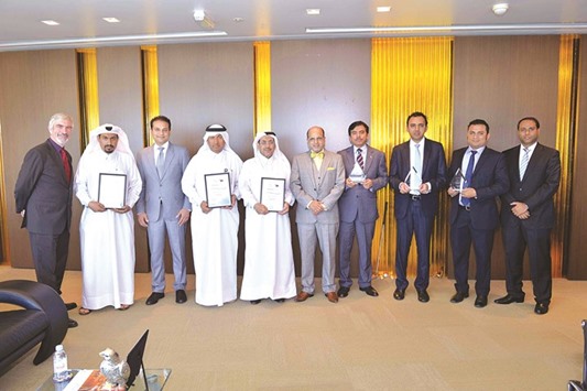 Doha Bank officials with the latest awards from u2018The Banker Middle East Industry Awardsu2019.