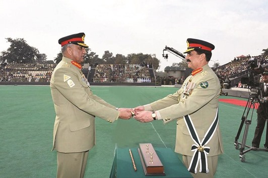 Pakistanu2019s new army chief General Qamar Javed Bajwa receives the change of command baton from the outgoing Chief of the Army Staff (COAS) General Raheel Sharif during the change of command ceremony in Rawalpindi, yesterday.