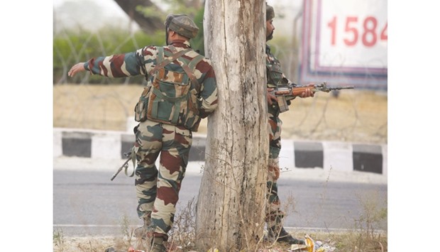 A soldier takes position during a gunbattle with armed militants at the army base at Nagrota, some 15km from Jammu yesterday.