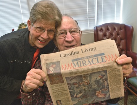 DOWN MEMORY LANE: James and Louise Brock hold a copy of the Charlotte Observer from November 29, 1987, showing a photo of his heart transplant operation. He remains the longest surviving heart transplant recipient whose operation was performed at Carolinas Medical Center.
