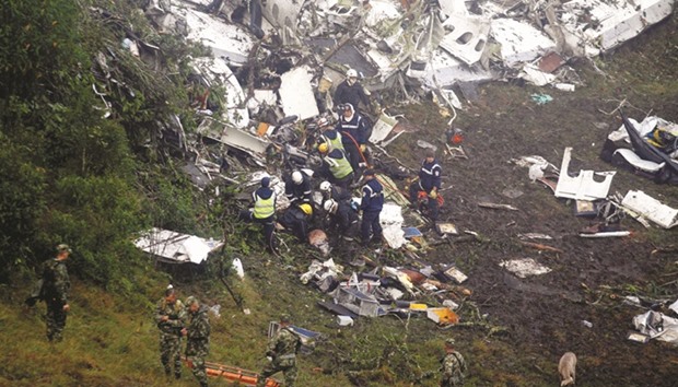 Rescue crew work in the wreckage from a plane that crashed into Colombian jungle with Brazilian football team Chapecoense, seen near Medellin, Colombia yesterday.