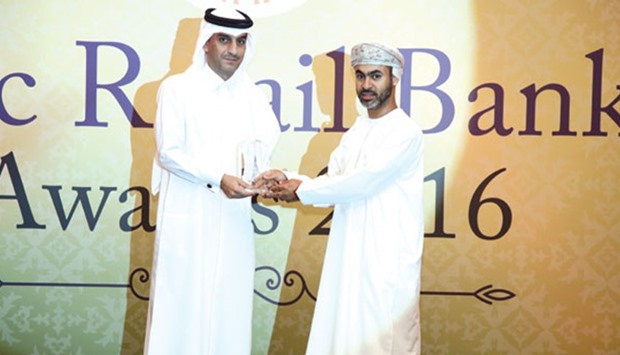 Al-Jamal (left) receiving the award on behalf of QIIB at an event in Dubai recently.