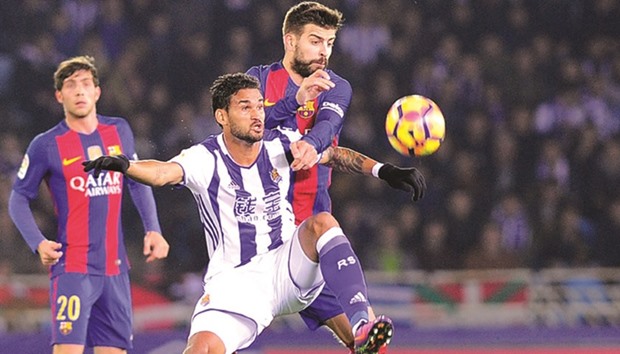 Barcelona defender Pique (R) during in action against Real Sociedad on Sunday.