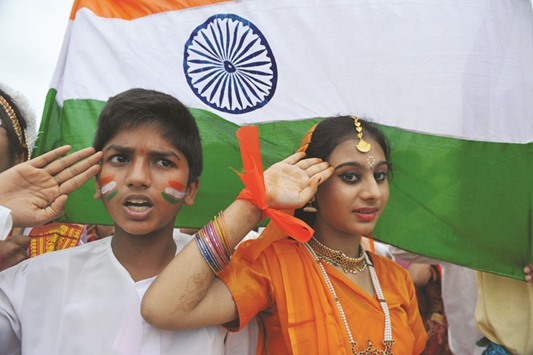 (FILES) In this photograph taken on August 30, 2012, Indian school children salute as they stand to attention and sing the national anthem u2018Jana Gana Manau2019 in Hyderabad. All cinemas must play the national anthem before screening movies and audiences should stand for it, Indiau2019s highest court ruled November 30, 2016, drawing angry accusations of an assault on civil liberties.