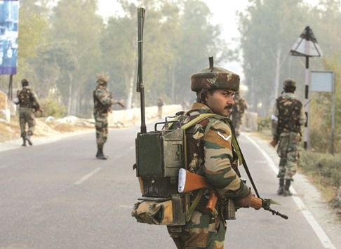 Soldiers patrol on the Jammu-Srinigar National Highway during a combing operation after a gunbattle with armed militants at an army base at Nagrota, some 15km from Jammu, yesterday. Seven soldiers were killed after militants disguised as policemen stormed the base near the frontier with Pakistan on Tuesday.