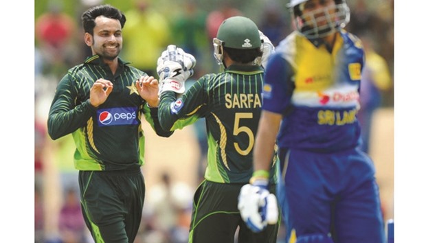 Pakistani allrounder Mohamed Hafeez (left) was banned from bowling for one year in July 2015.