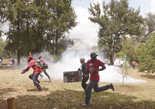 Protesters run from anti-riot police in Nairobi during a demonstration calling for President Kenyatta to take more effective action against political corruption.