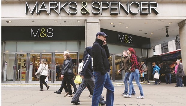 Pedestrians pass the Marks & Spencer Group store on Oxford Street in London. M&S is expected to announce plans next week to shut some stores at home and abroad, with analysts forecasting a slump in first-half profit and another fall in clothing sales.