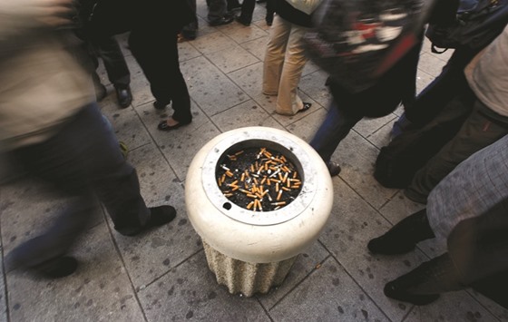 School students stand around an ashtray on the pavement outside their school in Nice, France.