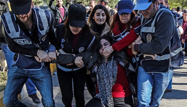 Turkish police officers detain former pro-Kurdish Peoples' Democracy Party (HDP) parliamentarian, Sebahat Tuncel (C) 