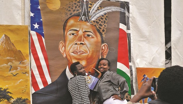 A July 23, 2015, file photo of Kenyan women posing for a photograph in front of a painted artwork depicting US President Barack Obama ahead of the US presidentu2019s visit to Kenya.