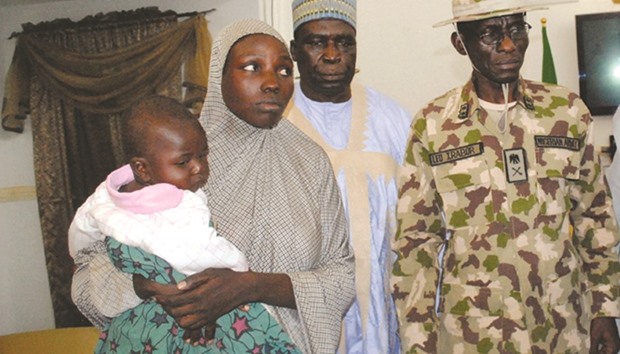 Maryam Ali Maiyanga carries her 10-month-old son at Government House in Maiduguri after her rescue yesterday.